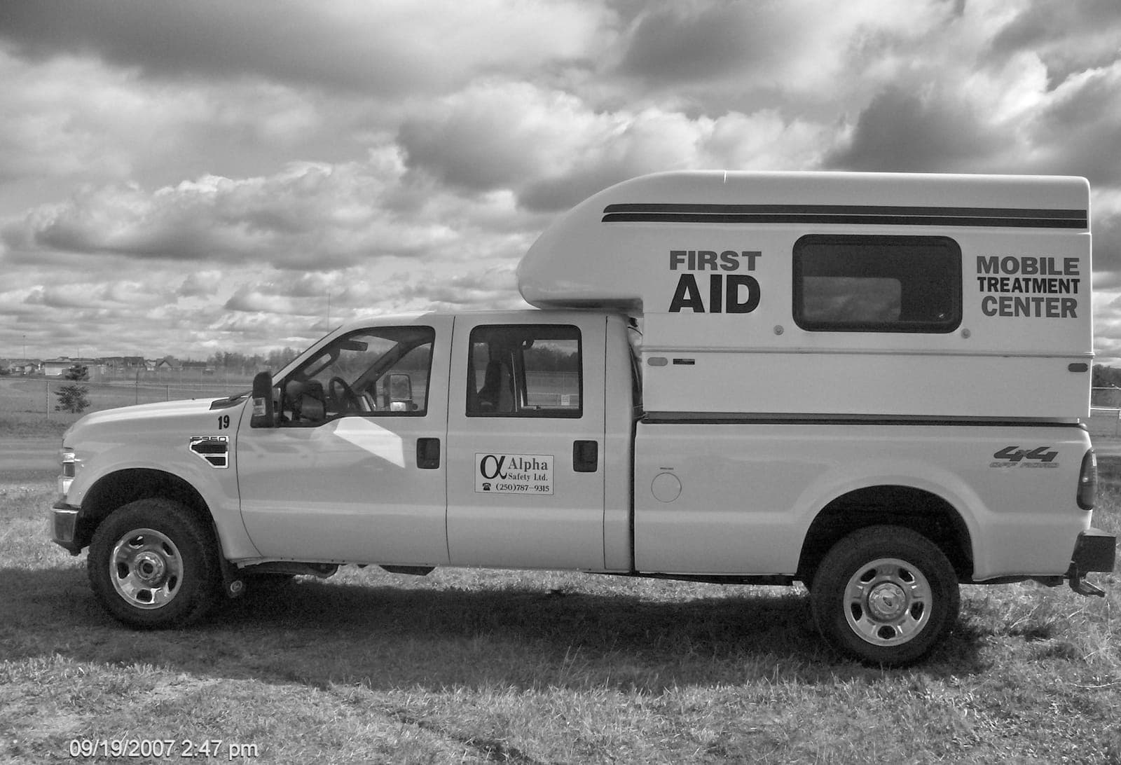 An Alpha Safety Mobile Treatment Center truck parked on a field site, 2007